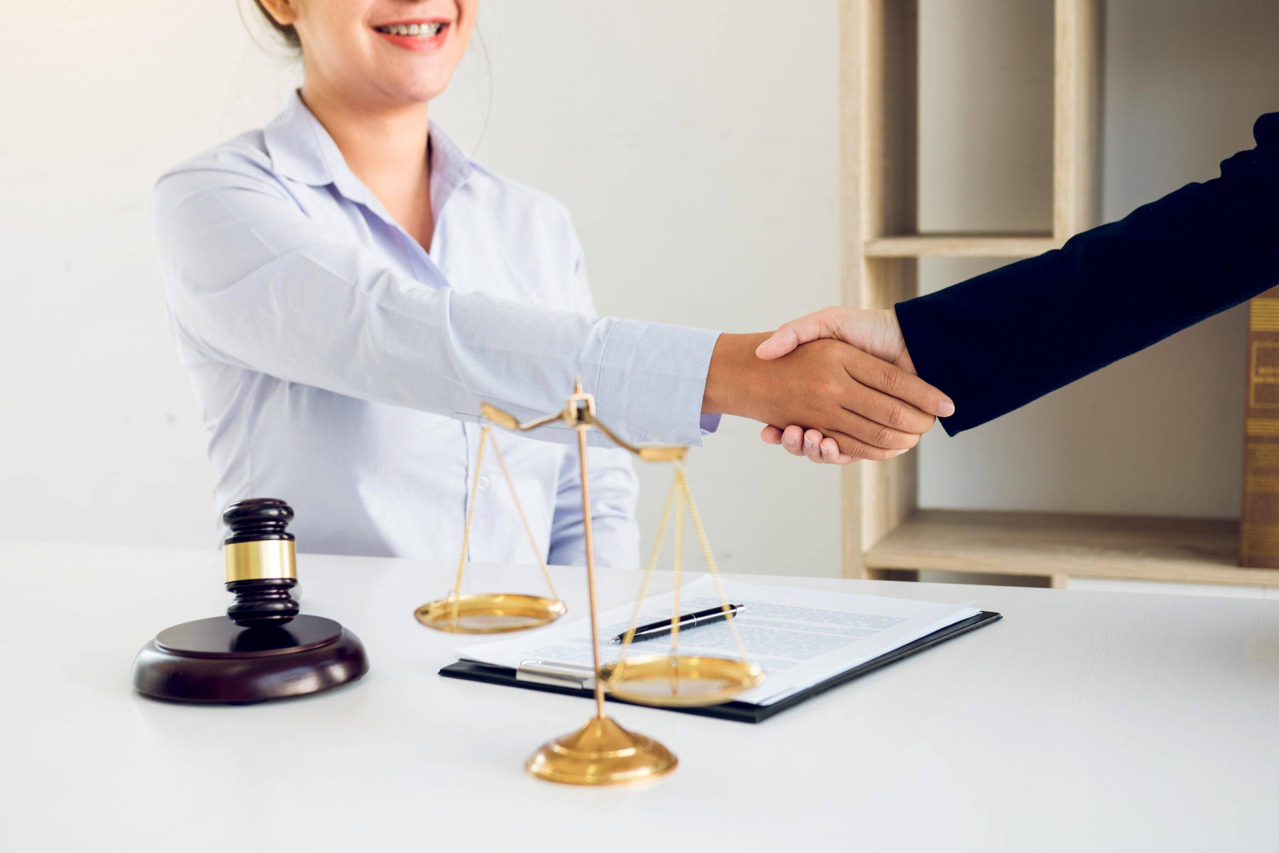 Lawyer is currently shaking hands with the client about the succ